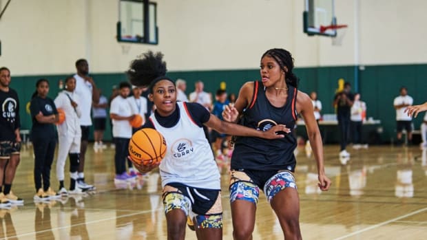 Two female basketball players compete at Stephen Curry's camp.